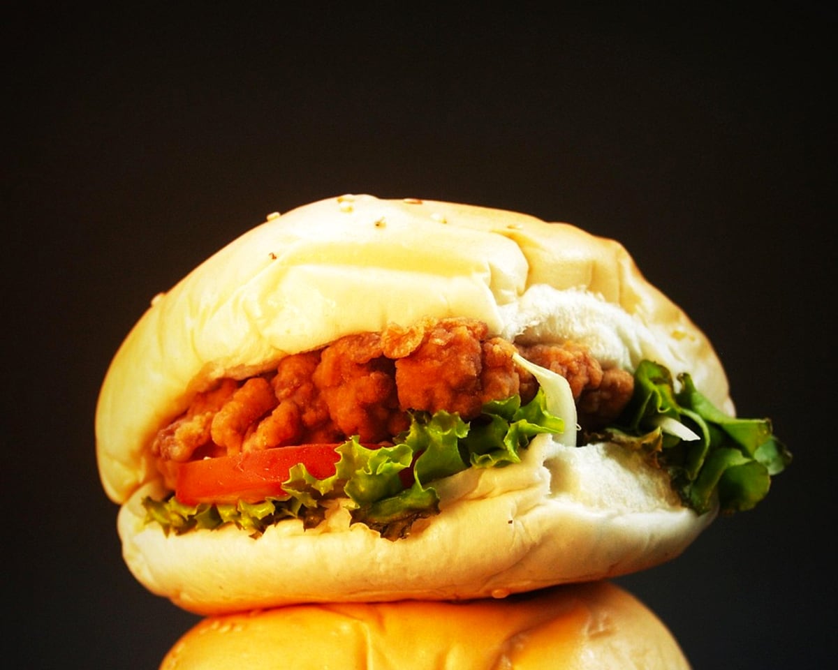 Crispy chicken burger with lettuce and tomato in a soft bun