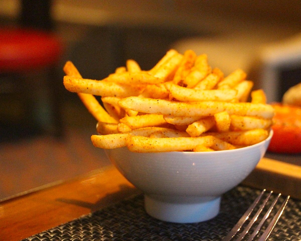 A bowl of hot fries under warm late-night light