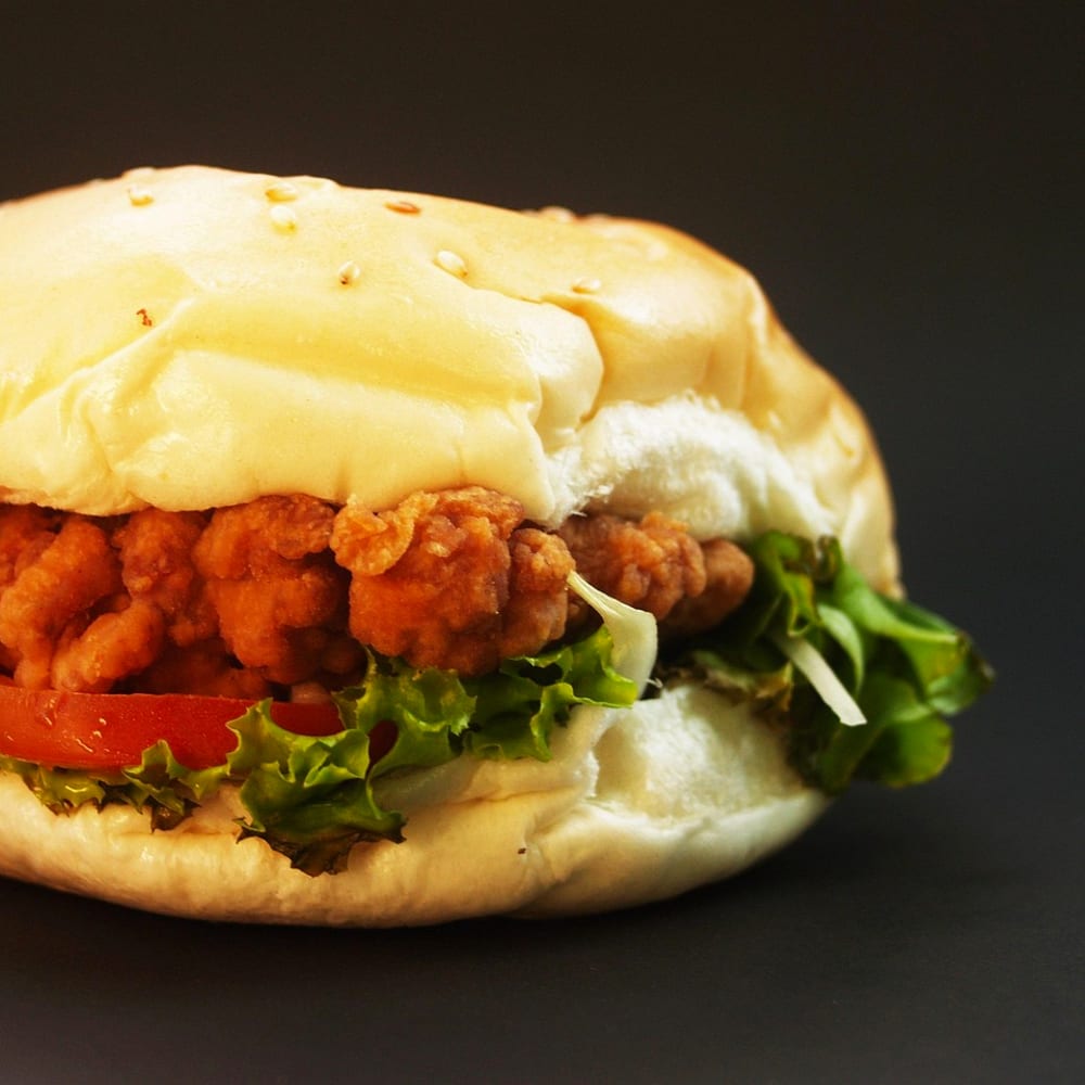 Crispy fried chicken burger with lettuce and tomato